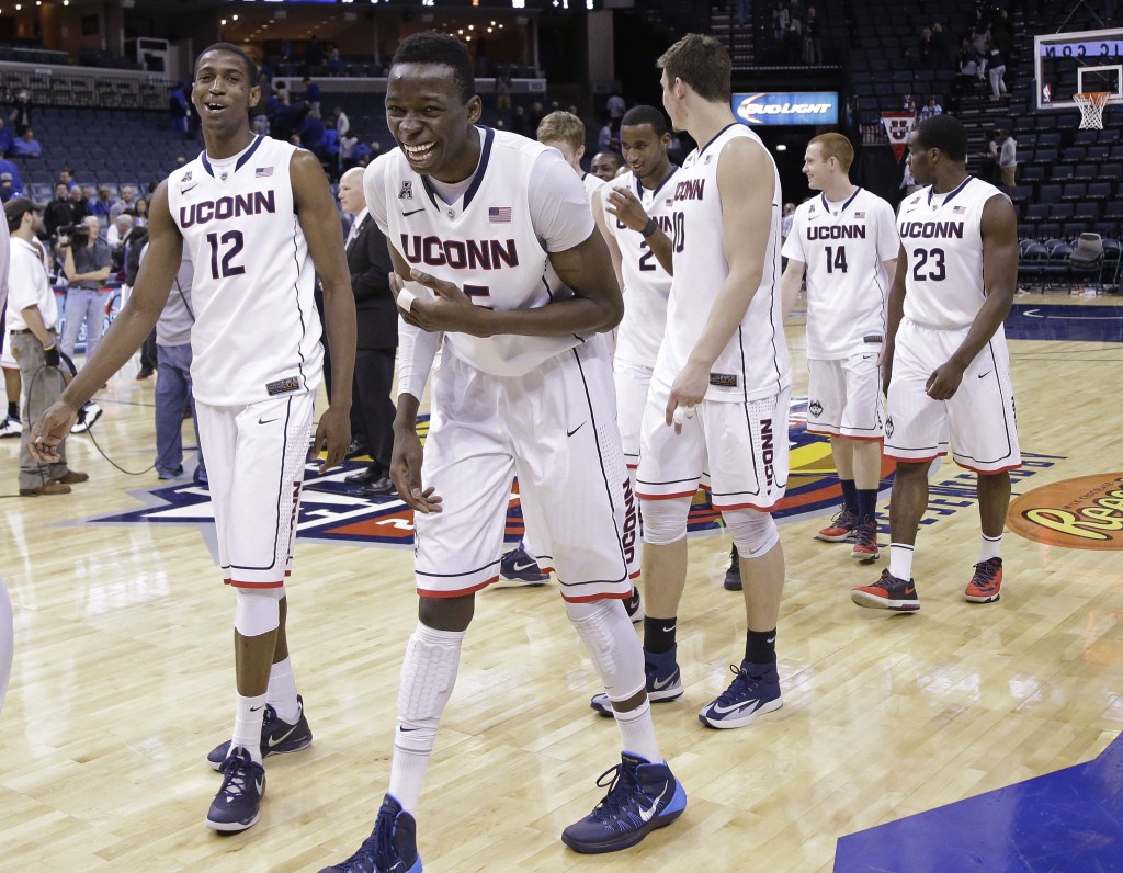 Connecticut center Amida Brimah, front, laughs as he leaves the court with Kentan Facey (12) after UConn defeated Memphis 72-53 in an NCAA college basketball game in the quarterfinals of the American Athletic Conference men's tournament Thursday, March 13, 2014, in Memphis, Tenn. (AP Photo/Mark Humphrey)